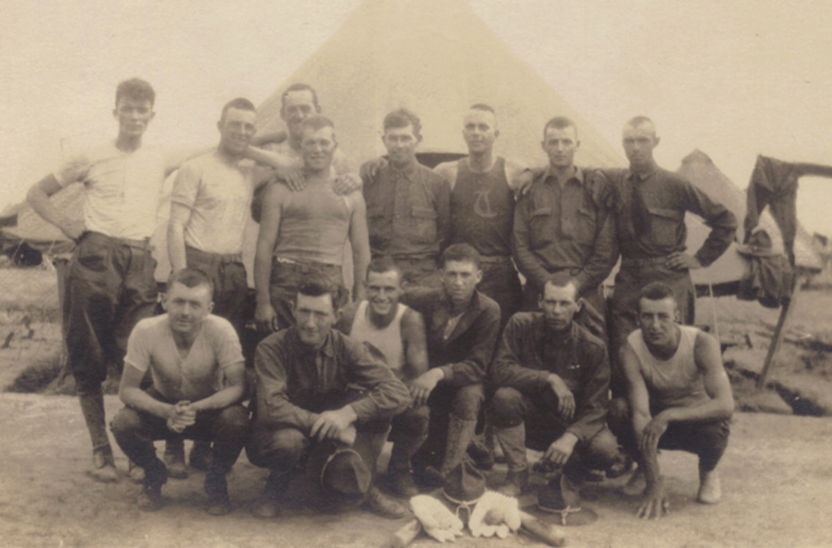  A group of National Guard soldiers gather around some of their baseball equipment for a photograph. The campaign hats and canvas leggings visible in this photograph would disappear and be replaced with more practical cloth caps and puttees after the soldiers arrived in France.