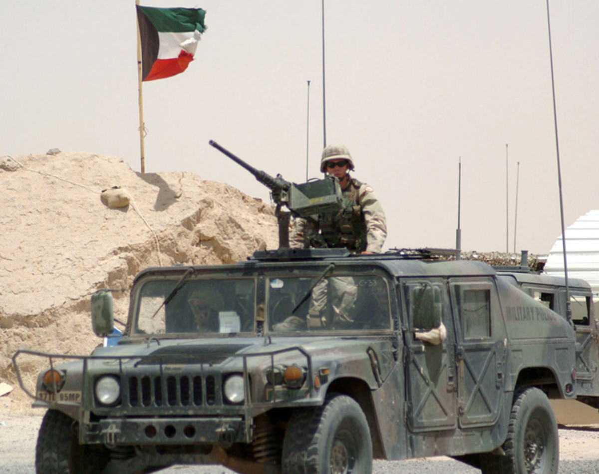  The slant-back M1025 series vehicles are among the most distinctive members of the HMMWV family. While originally separate designations were given to TOW missile carriers and armament carriers, that is no longer the case in US Army practice. US Army Military Police conduct a security patrol near the Iraq-Kuwait Border with this M1025A1 armament carrier in June, 2004. The Soldiers are assigned to the 201st Field Artillery Regiment, tasked with escorting truck convoys into and out of Iraq.