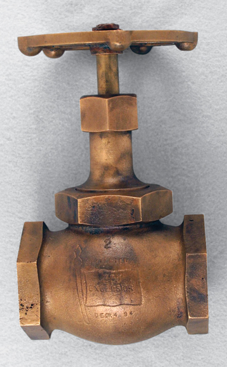  This steam valve was recovered from the San Diego. In the middle is the number “2” with the word “Patented” below followed by an etching of a flag pole and flag. Inside the flag are the letters “200 / Excelesior” with a date “Dec. 4 94” below. On the other side, not seen in the picture, are the words “Made By The Kelly & Jones Co” with a unique symbol in the middle.