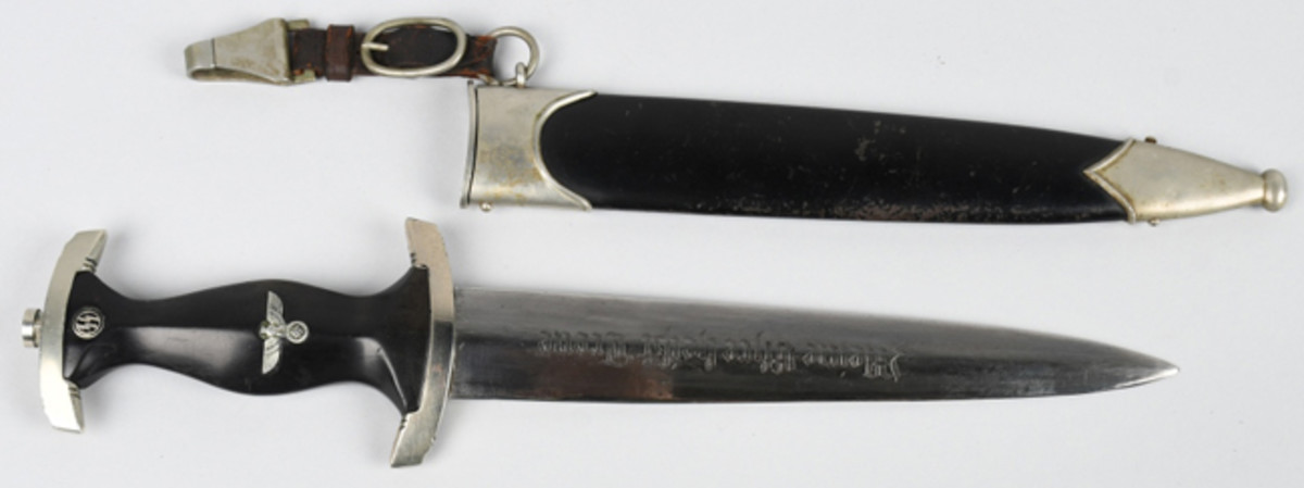  World War II Nazi SS M33 dedication dagger, circa 1933-37, approx. 22cm double-edged blade; plus scabbard. Etched with German phrase meaning ‘My Honor Is Loyalty.’ Image courtesy of Milestone Auctions