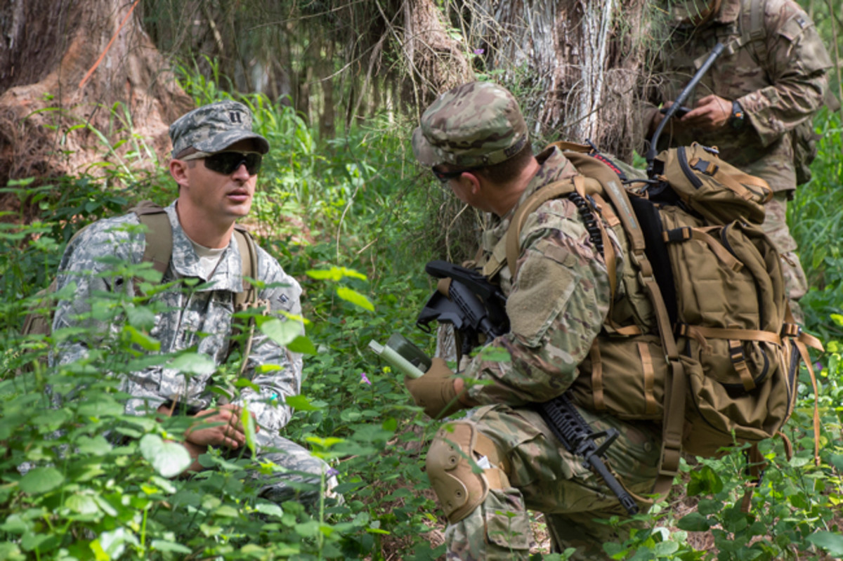  Capt. Darren Guree and Sgt. 1st Class Bryan Dennis of 112th Signal Batt. (Special Operations) (Airborne) - Special Operations Command Pacific, Signal Support Det, discuss the team's progress during Hammerhead Field Training Exercise/Situational Training Exercise 17-2, March 30, 2017. Capt. Darren Guree, left, is wearing the pixelated Universal Camouflage Pattern uniform. (U.S. Navy photo/Cynthia Z. De Leon)