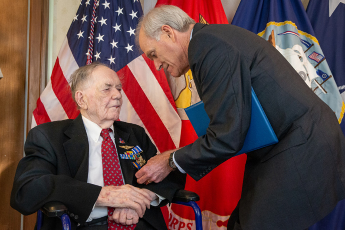  WASHINGTON (Sept. 10, 2019) Secretary of the Navy (SECNAV) Richard V. Spencer awards retired Aviation Machinist Mate 1st Class Bernard B. Bartusiak, 95, with two Distinguished Flying Cross medals and the Air Medal (Strike/Flight), 2nd-8th awards, for meritorious service during World War II involving aerial flight from April 20, 1943 to August 26, 1944. (U.S. Navy photo by Mass Communication Specialist 1st Class Paul L. Archer/Released)