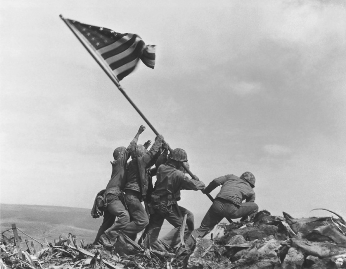 U.S. Marines of the 28th Regiment, 5th Division, raise the American flag atop Mt. Suribachi, Iwo Jima, on Feb. 23, 1945. (Joe Rosenthal/AP and retouched by by Alexis Jazz, via Wikimedia Commons)