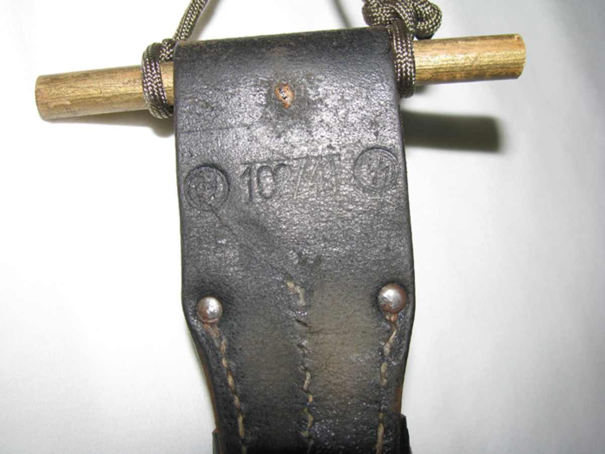 The reverse of the bayonet frog shows SS depot markings.