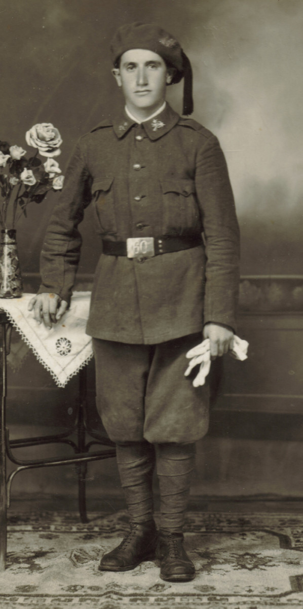 The 1926 dress regulations introduced Spain’s first truly modern uniform. The Model 1926 uniform was universal throughout the Army and was worn in dress, service and campaign modes. This soldier of the 60th Infantry Regiment “Ceuta” wears the winter version in olive wool with pressed wooden buttons. He displays brass Infantry branch insignia on his collar. His matching olive wool beret has a red tassel worn on dress occasions.