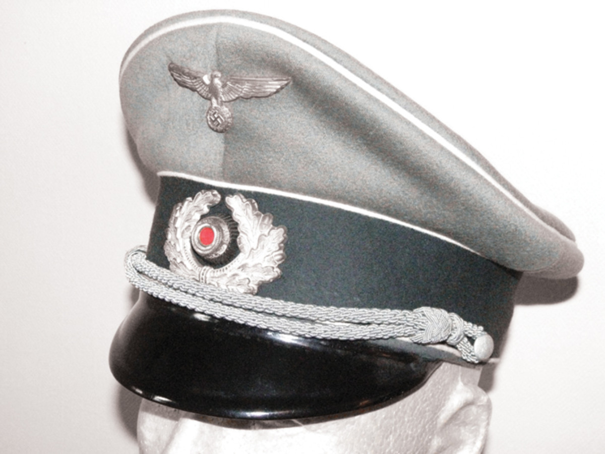 The infantry officer’s cap is made of high quality doeskin material, finely formed, and sewn with a dark green headband and white (infantry) piping.