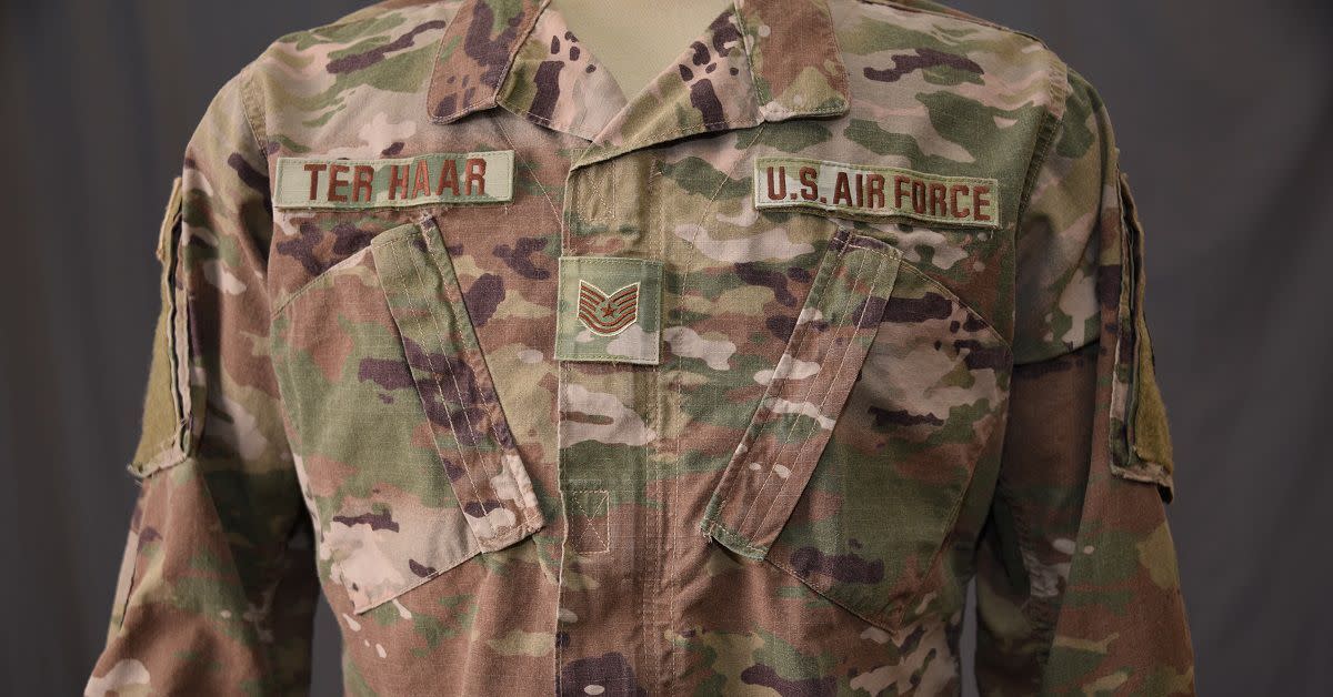 The Air Force's new Operational Camouflage Uniform has a smaller rank insignia displayed in the middle of the chest. The Air Force is switching to a lighter, three-color background for the Trank insignia, service and name tapes, and badges.