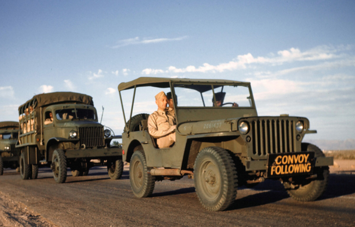 LAS VEGAS, NEVADA - CIRCA 1942: A convoy of Army trucks drives at the Las Vegas Army Air Force Airfield in Las Vegas, Nevada. Circa 1942. The suppressed Jeep with registration number 2061437 in lusterless blue paint on the hood leads a column of G-506 Chevrolet 1-1/2-ton trucks.