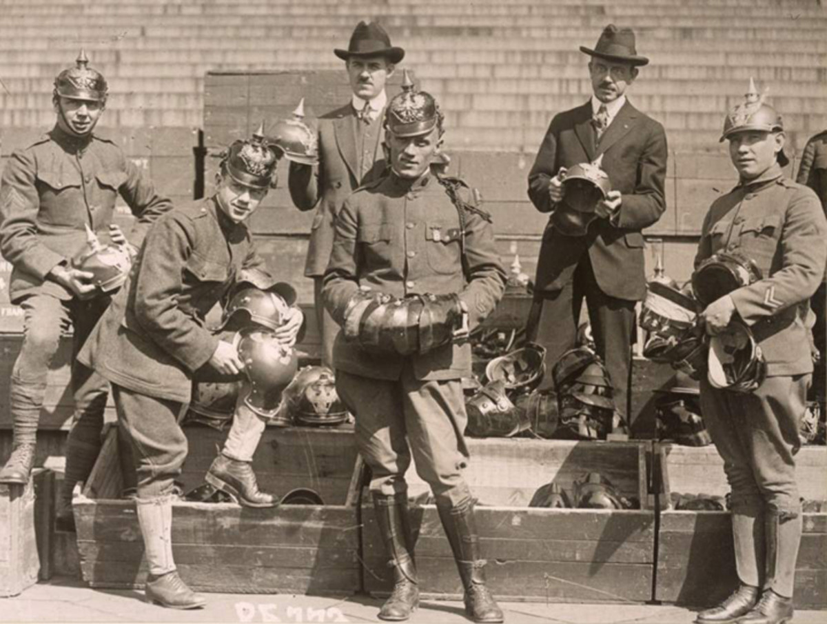US doughboys try on souvenir German helmets in front of the US Treasury Building, April 22, 1919.