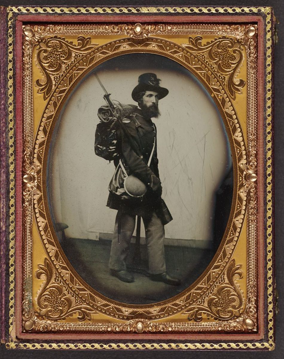 Private Albert H. Davis of Co. E, 9th New Hampshire Infantry Regiment with Model 1841 Mississippi rifle and sword bayonet.
