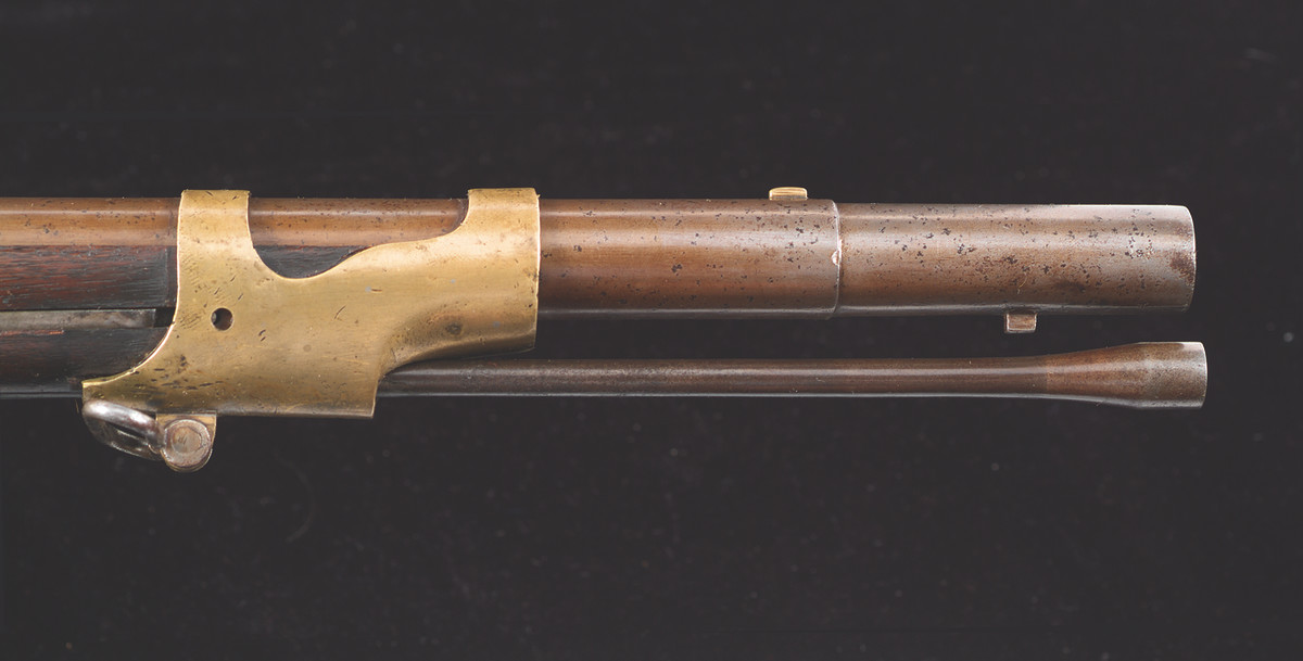 New York City gunsmith Frederick H. Grosz turned town the barrel of the each rifle to the inner diameter of the Model 1842 socket bayonets from the muzzle for 2-11/16”. He moved the brass blade front sight behind the turning. Finally, he brazed a square bayonet stud on the underside of the turned town section to act as the bayonet’s retainer.