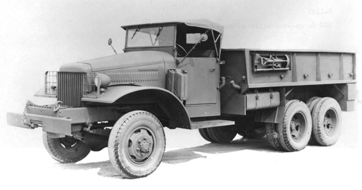 Pioneer tools were mounted on the forward outside portion of the cargo body on the driver's side. Notice also the fuel can and bracket mounted on the left front fender. Most of the USMC vehicles were equipped with a 10000-pound capacity PTO driven front winch and an open cab.