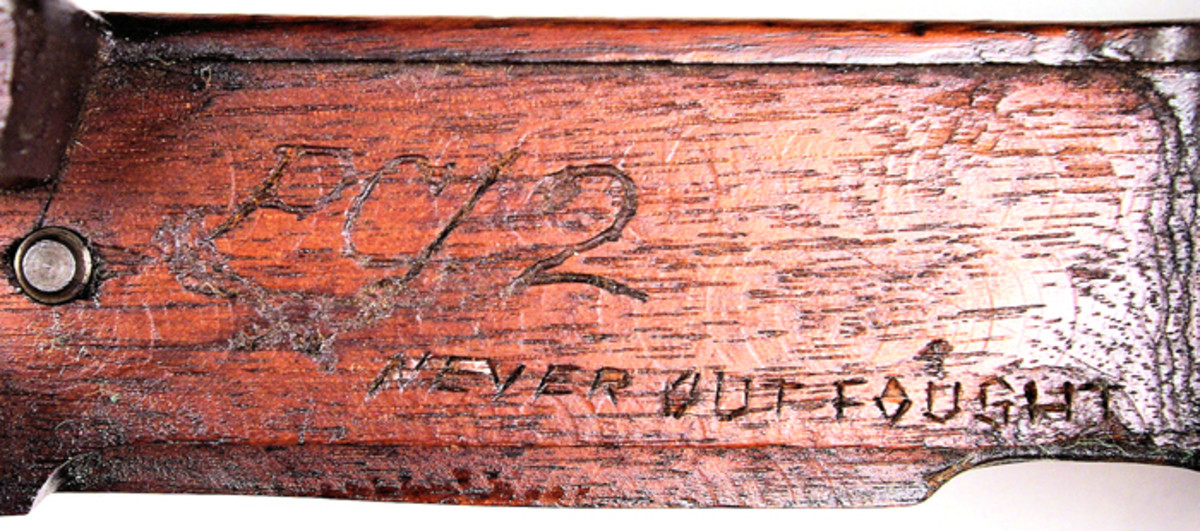Removing the bolt mechanism revealed the markings, ”PC/2 NEVER OUT FOUGHT” carved on the Krag stock.