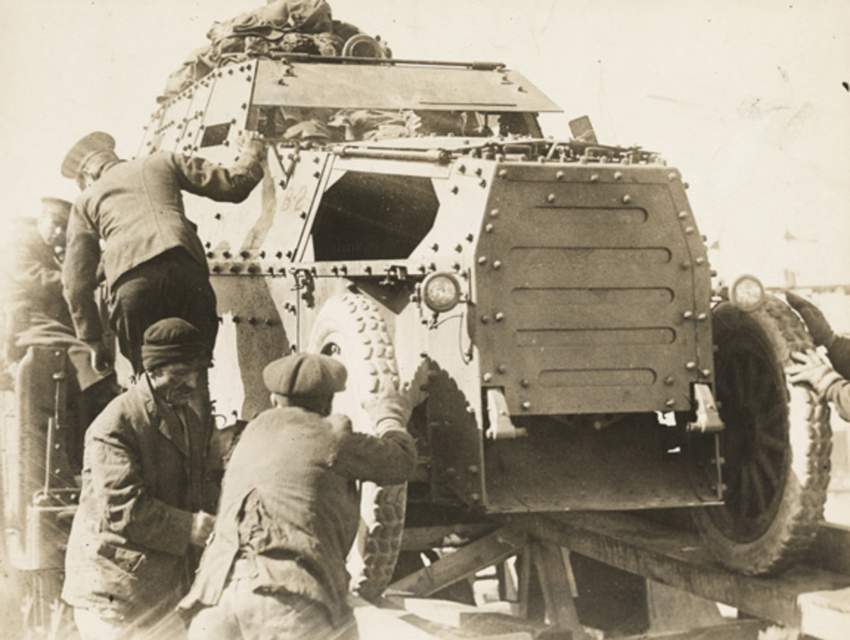 Armored car of the 1st Armored Motor Battery, NYNG on a railroad car.