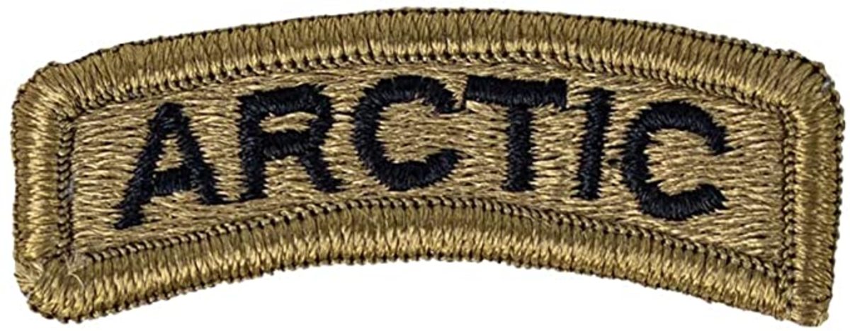 The Arctic Tab represents a Soldier’s ability to train and thrive in cold environments. Originally worn below a Soldier’s unit patch, the Arctic Tab now rests above the patch and can now be worn throughout the U.S. Army Pacific Theater, according to a new USARPAC policy approved in February 2020. The previously rectangular-shaped tab was redesigned in November 2019 and now also sports the familiar rainbow arc of similar tabs.