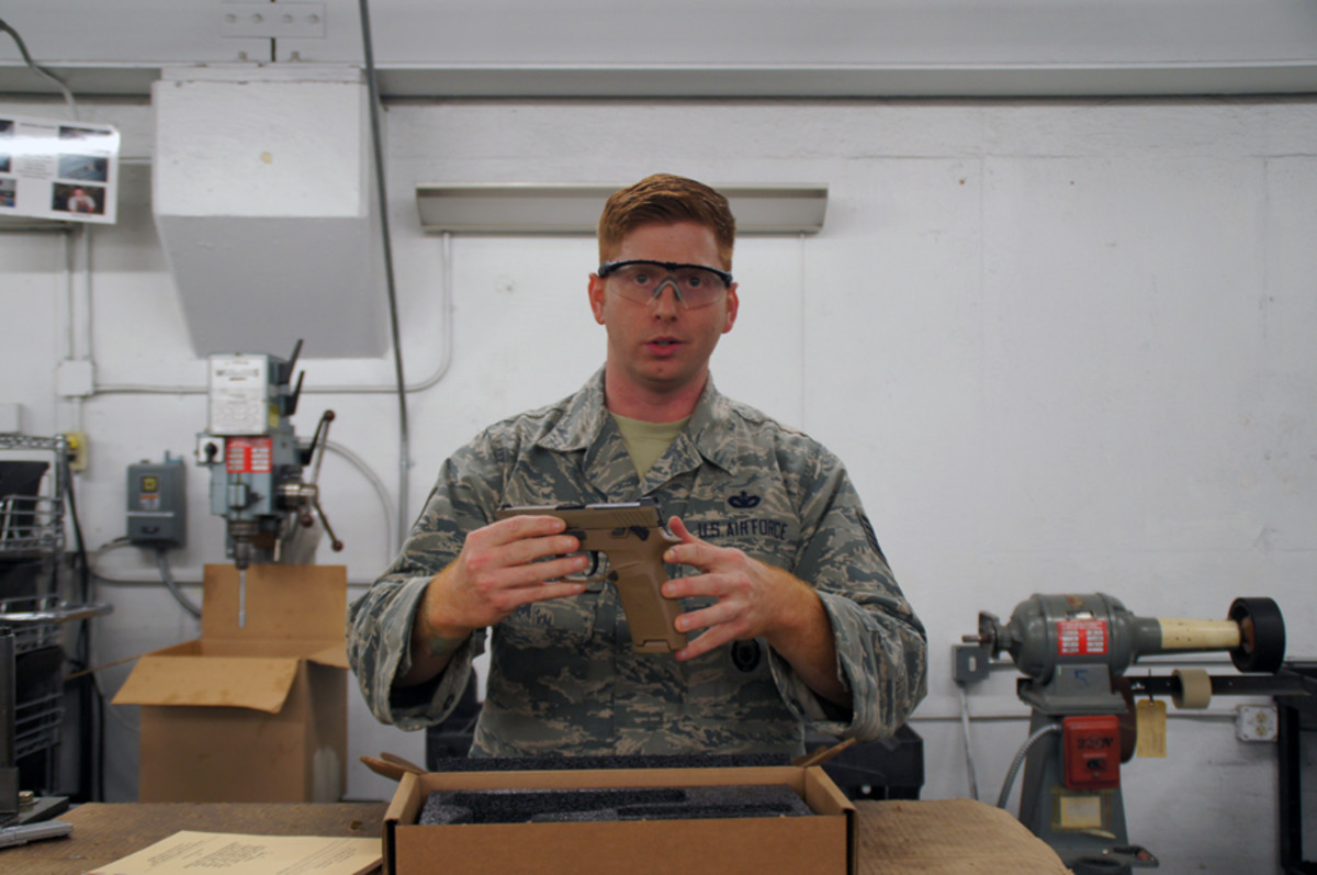 Tech. Sgt. Brady Craddock, non-commissioned officer in charge of the Air Force Gunsmith Shop, explains the benefits of the M18 modular handgun system. The Air Force Security Forces Center, in partnership with the Air Force Small Arms Program Office, has begun fielding the new M18 to Security Forces units.