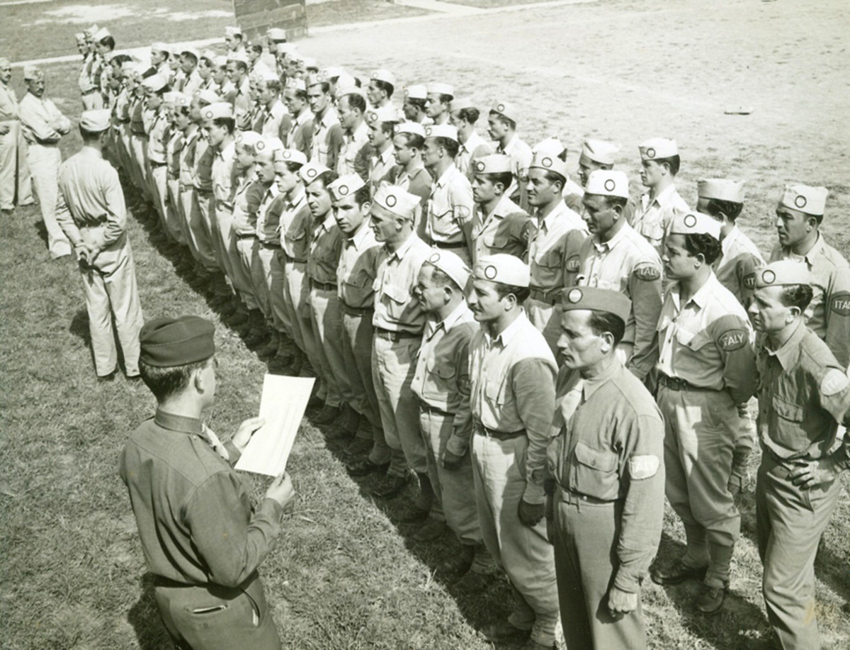 "Chicago – Capt. Alexander Wood calls roll of Italian Service Unit, composed of Italian prisoners of war who are carefully selected on the basis of not having Fascist sympathies, as they check in at Vaughan Hospital in Hines, Illinois, to perform service duties.