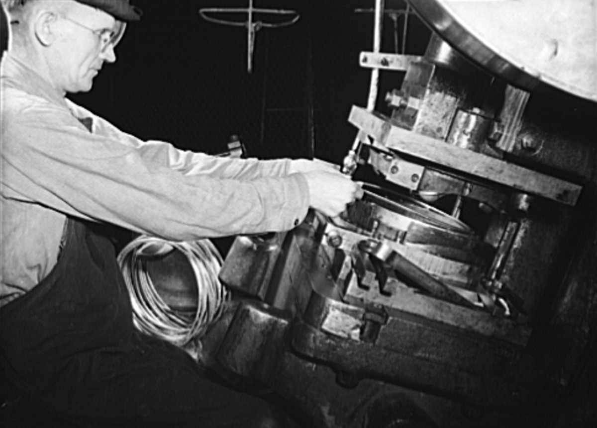 Figure 6. This operator is joining a steel reinforcing rim on an army helmet. The stamping press that performed this operation was one of many that formerly turned out auto radiator parts McCord.