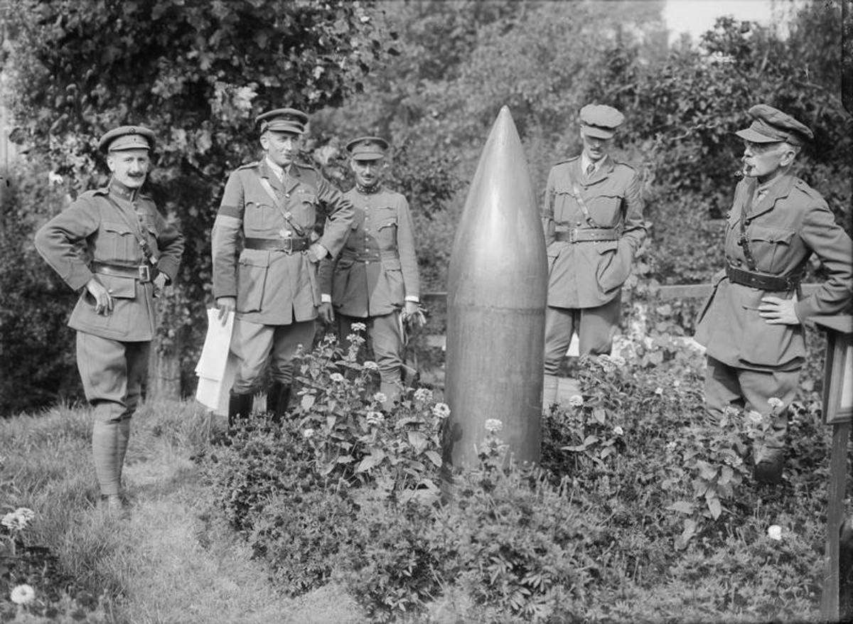 Soldiers examining an unexploded artillery shell.