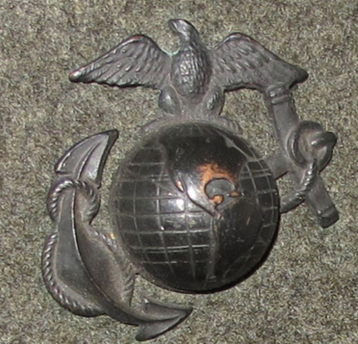 Enlisted pattern eagle, globe, and anchor insignia as authorized for wear on the hat.