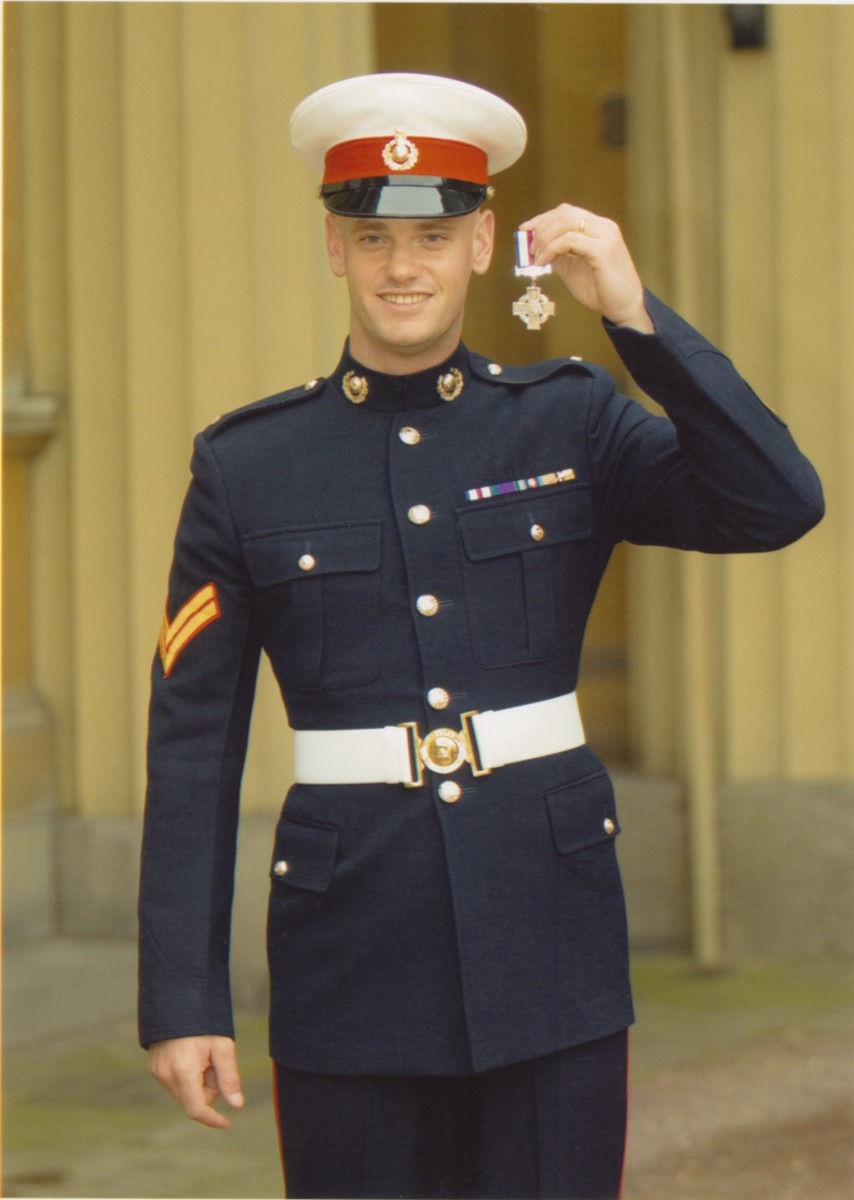 Image of Warrant Officer J.T. Thompson, in uniform, holding his  C.G.C.