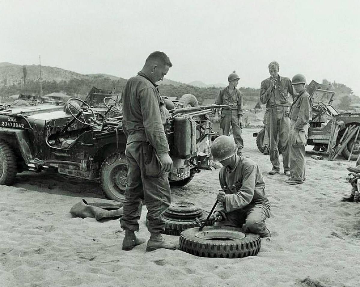 Changing split rim 27th Regiment. Korea, 8 August 1950.