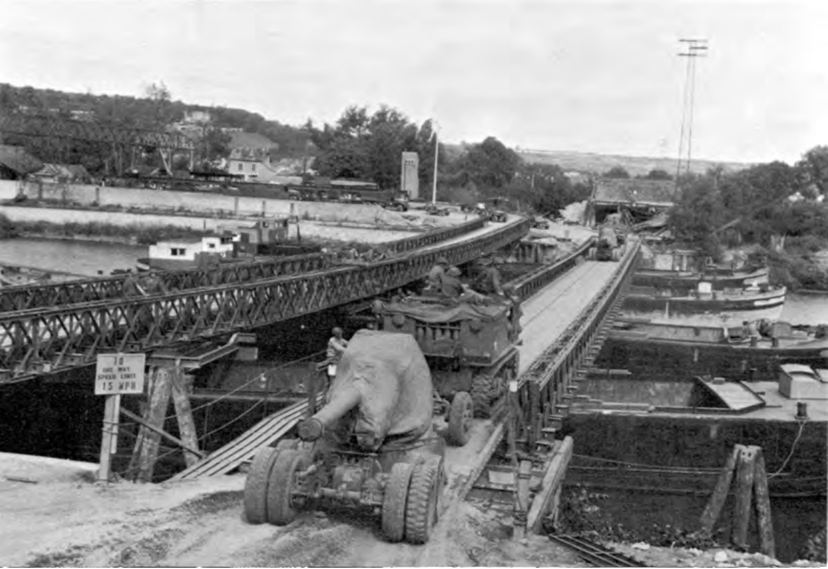 Barges being used to support Bailey bridging over the Seine at Mantes, France, August 1944.