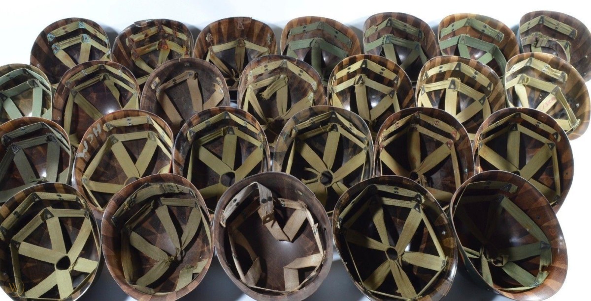 Four rows of upturned helmet liners showing web interiors