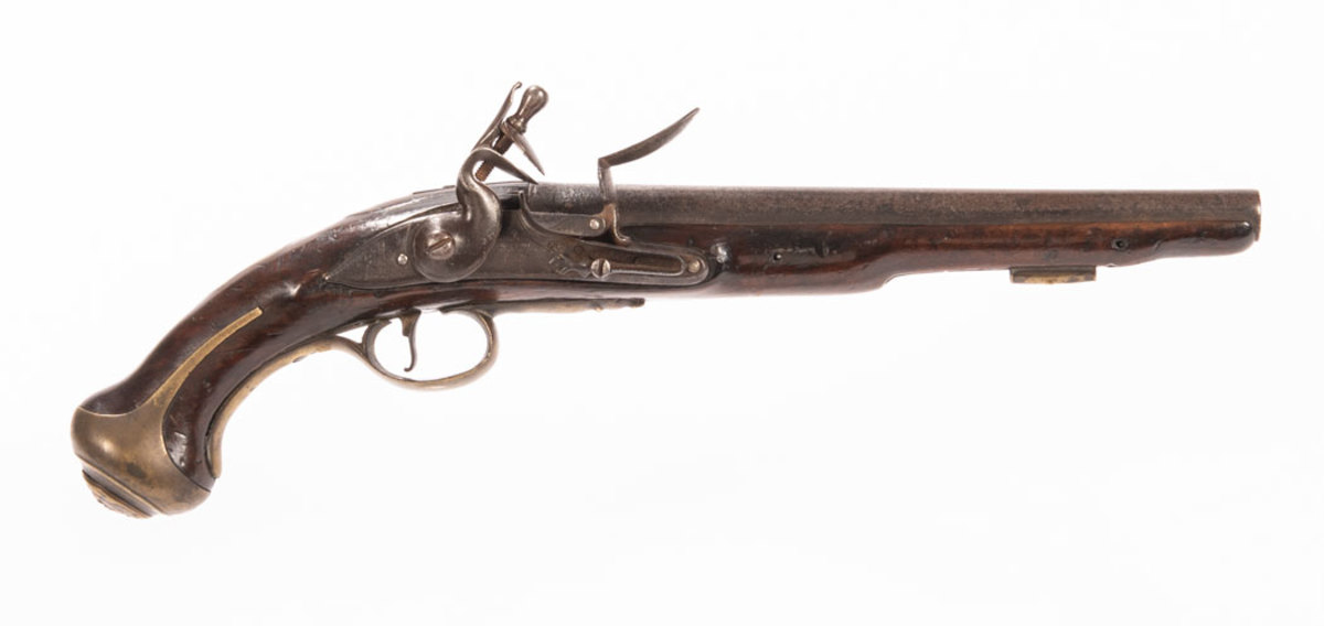 British Colonel Churchill's 10th Dragoons Regiment Pistol, c. 1743- 44 British Colonel Churchill's 10th Dragoons Regiment Pistol, c. 1743- 44, 10 in., .60 caliber barrel with ring decorated breech, engraved on the top "CHURCHILL," Tower ordance proof marks at the top of the breech, stamped "41" on the left side of the breech, the breech plug tang stamped with a crown over crossed scepters mark at the top and a crown at the bottom; curved double bridle lock with double line border engraving, pointed tail engraved "TOWER/1742," engraved below the pain with a crown over "GR" and stamped crown broad arrow mark, the inside of the lock plate maked with a crown over "7" inspector's mark next to another incomplete mark, the tumbler bridle and tail of the lock plate with "VIII" assembly numbers, the side nails with assembly numbers "VI" and "VII"; walnut stock with carved plateau around the breech plug tang, storekeeper's mark stamped to the rear of the lock mortice, the inside of the side plate mortice with assembly number "VII" and the number "4" punched into the surface twice, and the rammer channel marked "ES" between the rammer pipe and stock entry; brass furniture including a butt cap with long ears and grotesque mask retaining stud, thumb piece engraved "T.1/29," trigger guard with acorn finial, convex side plate marked on the inside surface with assembly number "VII," and single cast brass rammer pipe, no rammer, overall lg. 16 1/2 in. Literature: This pistol is illustrated and described in Robert Brooker, British Military Pistols and Associated Edged Weapons (Robert Brooker, 2016), p. 89.