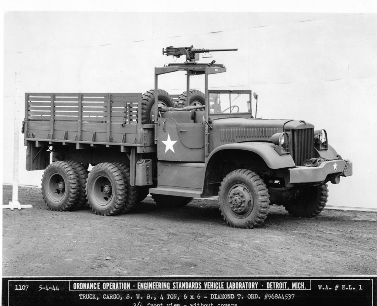 Diamond T SWB 4 TON soft RFS no canvas G-509.JPG The same truck is shown with the cab top and the tarpaulin removed. The sideboards consisted of two wooden planks, one over the other. The smooth panel below the right door was the cover for the battery box, which contained two six-volt batteries. Wired in parallel, the batteries powered a six-volt circuit for lights, ignition, charging, and so forth, and twelve volts for the starter.
