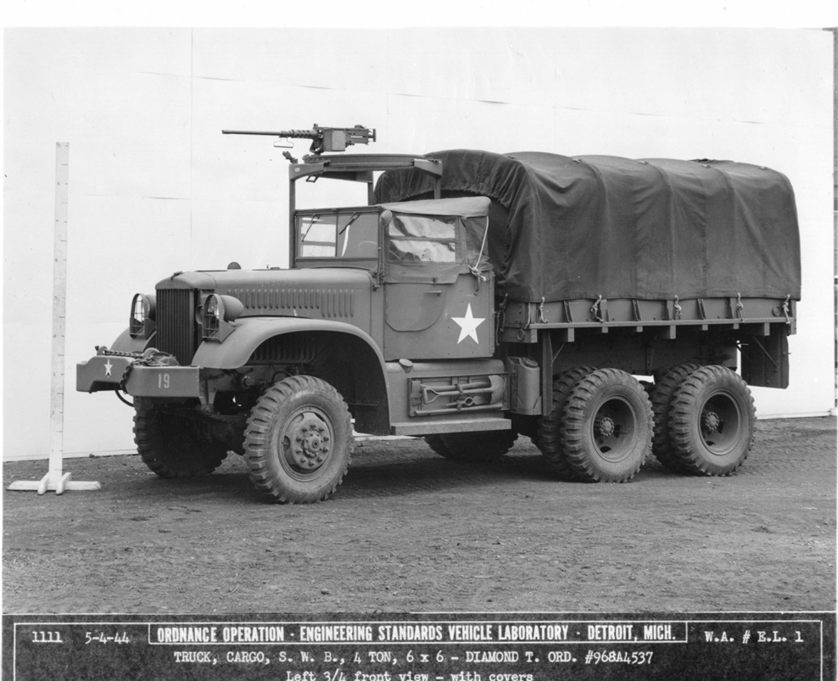 The military standard open cab was introduced to the Diamond T four-ton, short-wheelbase, 6x6 trucks starting with serial number 968A4390. As seen in this series of photographs of serial number 968A4537 dated 4 May 1944, the cab top was at about the same level as the hood, and had a folding windshield, doors, and a canvas top with door curtains with soft-plastic windows. A ring mount and Browning M2 HB .50-caliber machine gun are above the cab. Also, this truck had the wooden body, part number DT-N27636, which replaced the steel body.