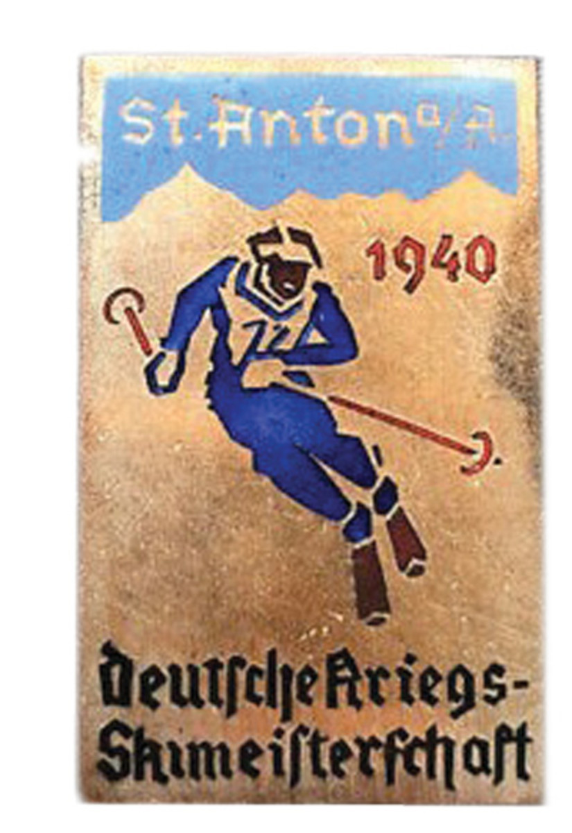 A 1940 German War Ski Championship Badge for an event held in February 1940 in St. Anton am Arlberg, Austria. What is interesting about this badge is that it shows the Germans still held ski competitions a year into World War II. The badge is constructed of silvered bronze with enamel features displaying a downhill skier. The badge is approximately 40 X 25 cm with a vertical pin on the reverse. These badges retail for around $150.
