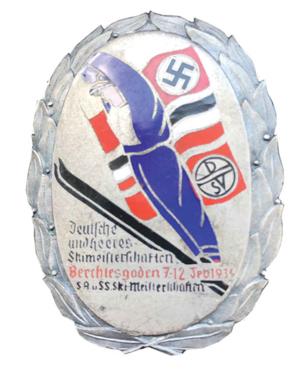 A 1934 SA-SS Ski Competition Badge for the event held on February 7-12, 1934, in Berchtesgaden, Germany. This beautiful silver-plated, bronze and enamel badge displays a downhill skier superimposed on the black, white and red national swastika flag, the black, white and red national tri-color flag and the red DSV (German Ski Association) flag. When translated it says “German Army Ski Championship, Berchtesgaden, 7-12 Feb. 1934 SA and SS Ski Championship.” Interestingly, this SA-SS ski competition was held approximately five months before the infamous “Night of the Long Knives/Röhm-Putsch” beginning on June 30,1934, when the SA ranks were decimated by the SS. The badge is approximately 58 X 43 mm and has a vertical pin on the back. These badges can be found for around $200-$250 depending upon condition