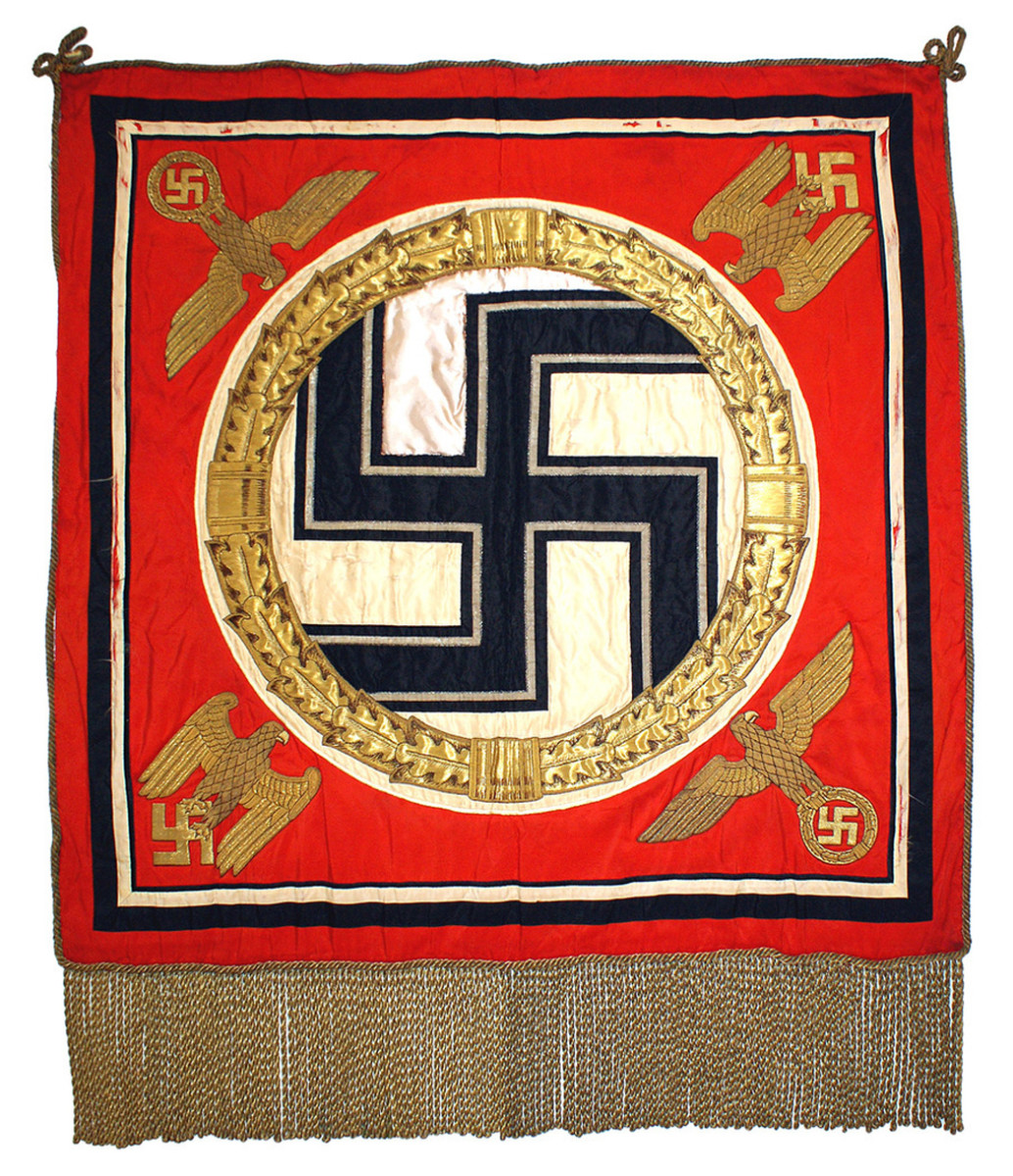 Third Reich Fuhrer Standarte, 39 inches by 38 inches, the rich red field featuring a design of a black silk static swastika within a high relief gold bullion and gold leaf wreath.