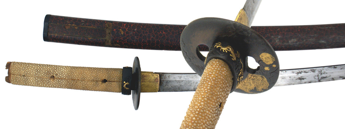 Japanese antique wakizashi with 18 ½ inch curved delicate blade, gray with black splotches, gold “cat’s paw” scratched habaki and an unusual engraved tsuba.
