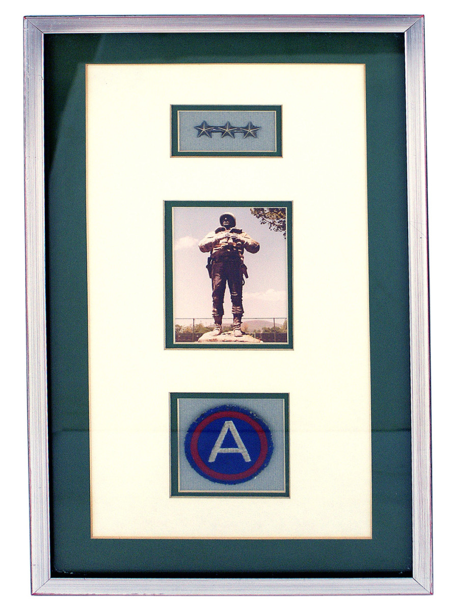 Framed three-star insignia worn by Gen. George S. Patton, Jr. during World War II, plus a photo of Patton when he visited West Point, and a US Third Army shoulder patch.
