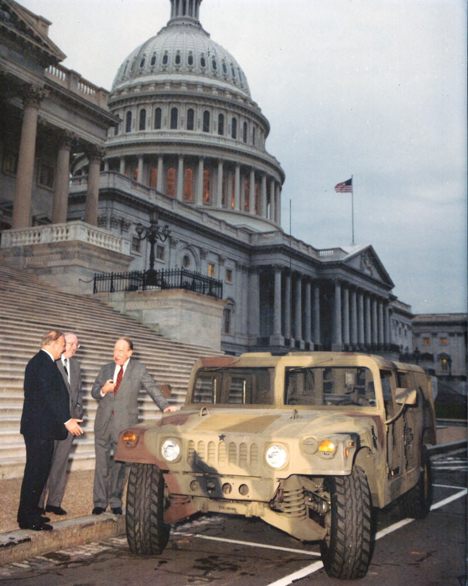 Outside the US Capitol, AM General President Larry Hyde, left, shows an early HMMWV to Congressman Joseph Addabbo, Sr. (D-NY), right, and an unidentified individual. The March 22, 1983, $1.2 billion, 5-year award was the largest contract AM General had received to that point.