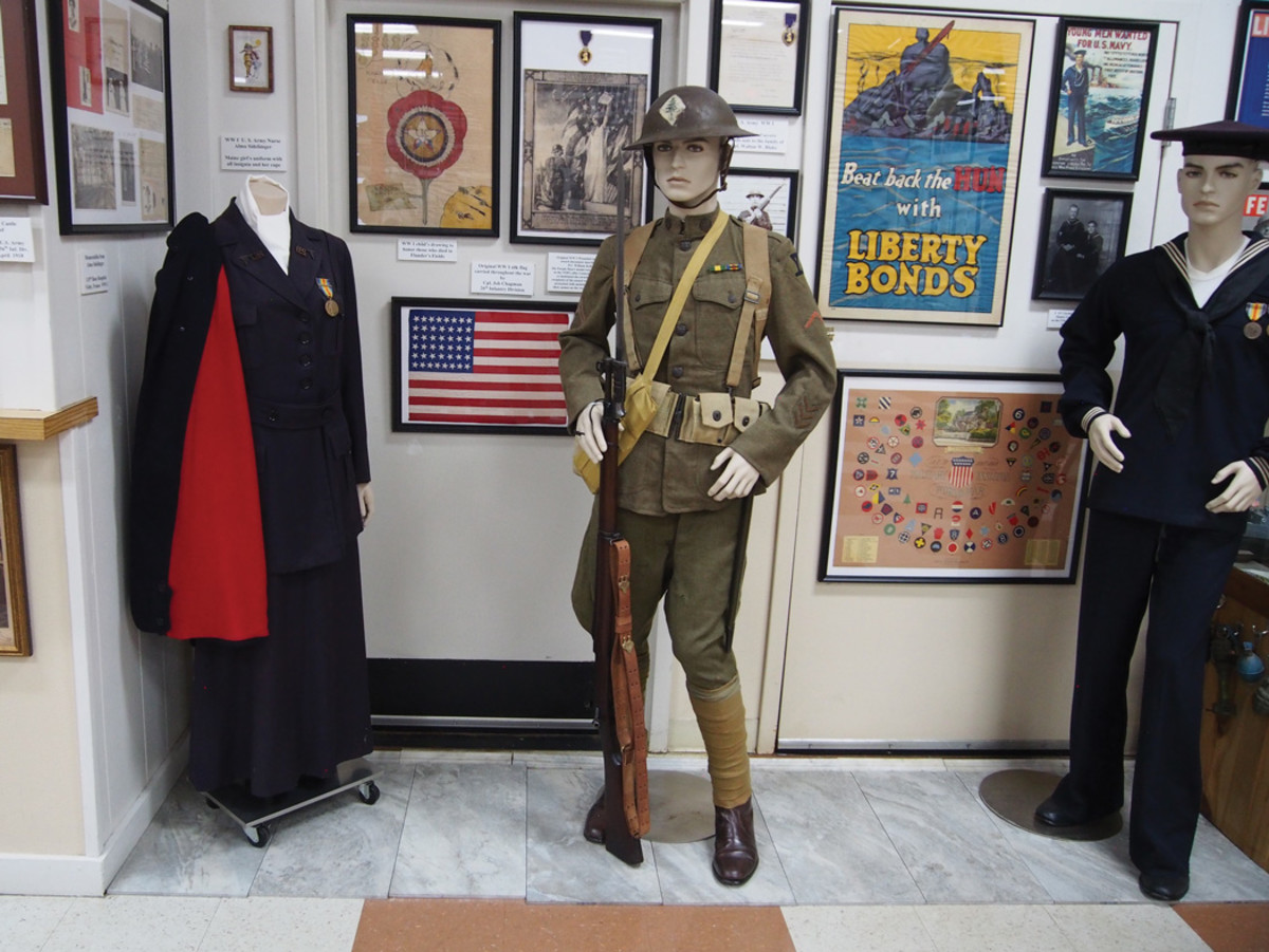 The soldier is the center point of this World War I display that shoes the uniforms and artwork that bring the scene to attention.
