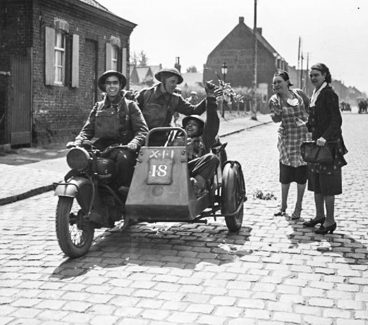 Men riding on a Big 4 in France, probably in early 1940.