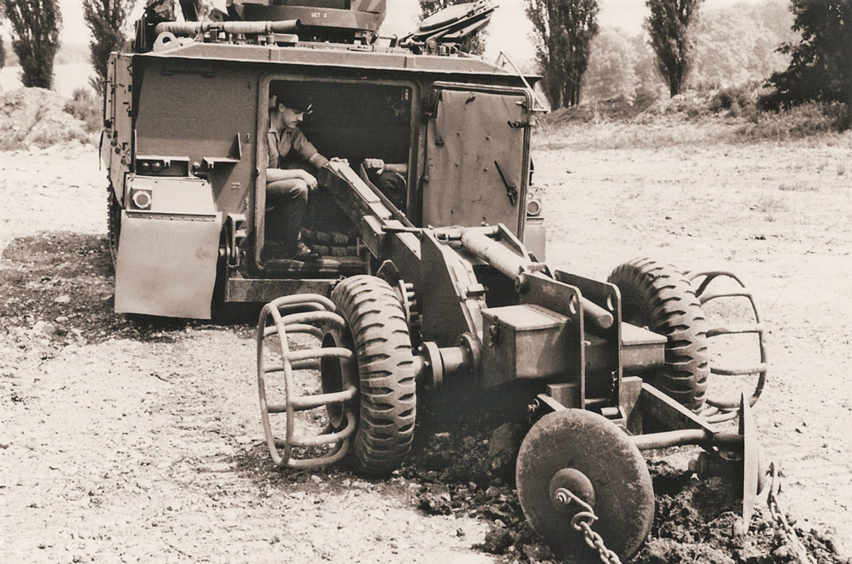Royal Engineers laying anti-tank mines using the ‘Bar Mine’ system from the rear of an FV432.
