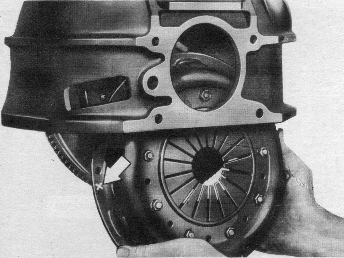 On many HMVs, such as the CCKW shown here, the bottom of the bell housing is open and has a removable cover. After removing the transmission, the clutch assembly and engine flywheel can be taken out. However, this is not the case with most U.S. military jeeps. Note that this is a diaphragm type clutch as used on most WWII vehicles manufactured by General Motors.
