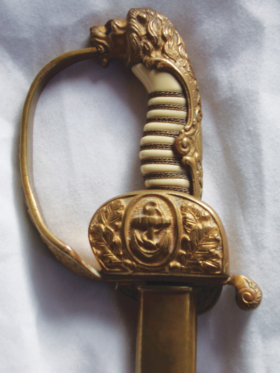 A standard Third Reich lion’s head naval sword with engraved blade and celluloid handle.