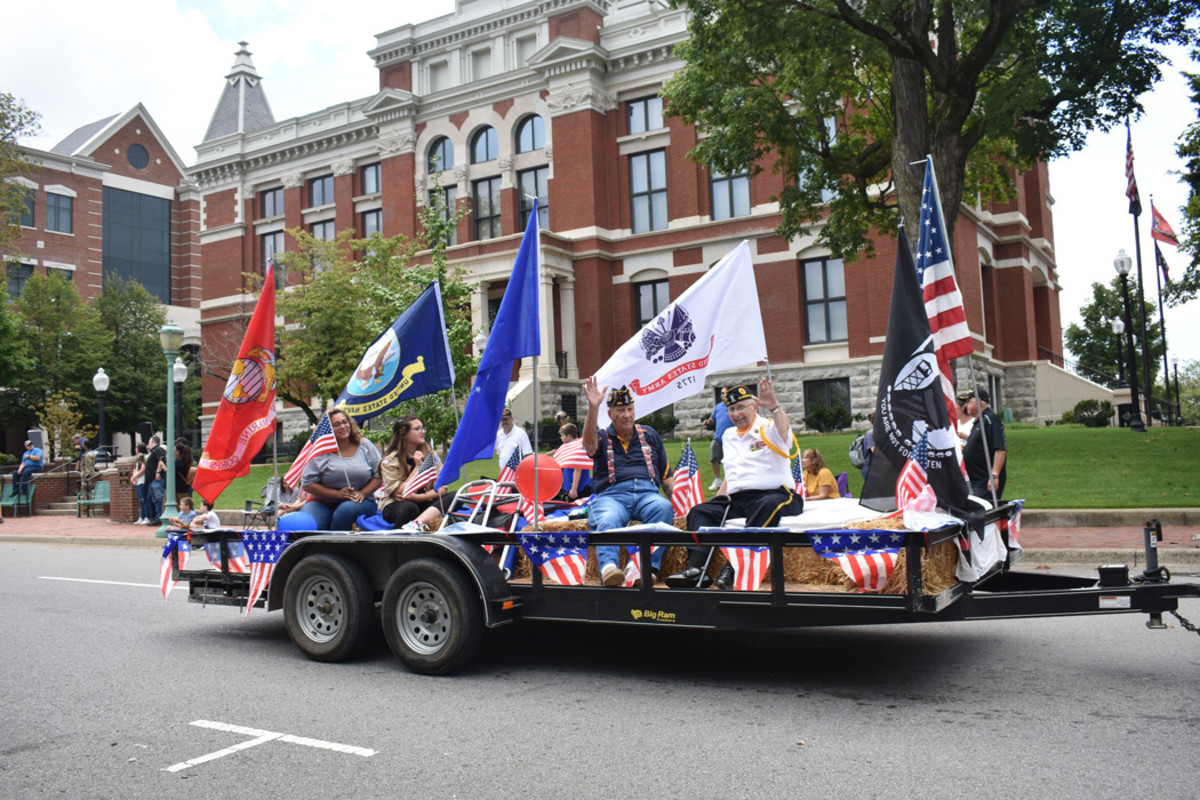 Veterans and supporters ride on a float through Downtown Clarksville during the 2021 Welcome Home Veterans Parade.