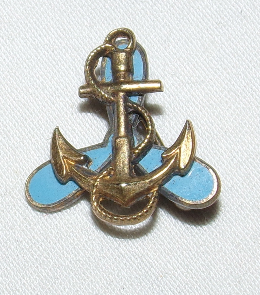 A small WAVE pin with gold anchor and blue enamel propeller.