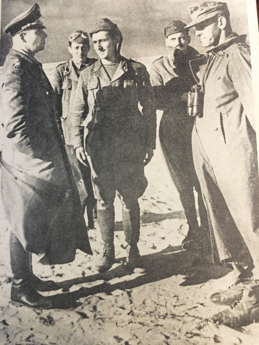Field Marshal Erwin Rommel shown on a German period postcard with some Italian soldiers. Note the German tropical boots on the German officer on the far right made with fabric and leather and similar to those found by the author.