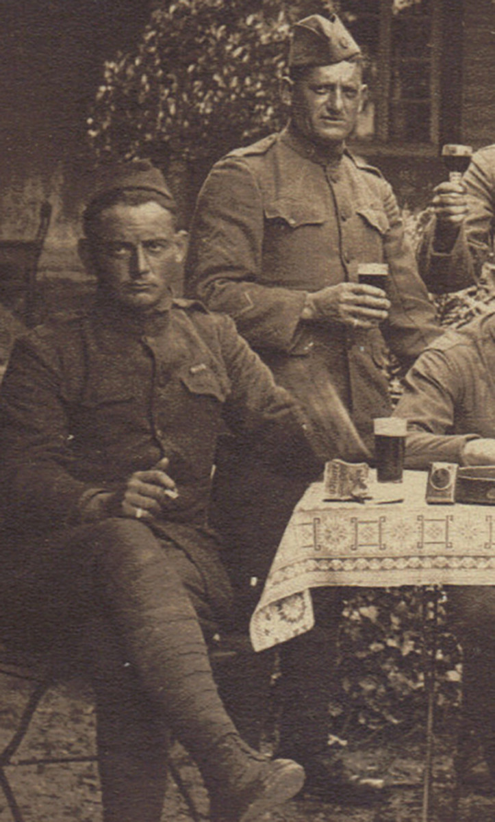 These two hard-looking characters seem to find nothing amusing in having their drinking interrupted for a picture. The sergeant, standing, displays a wound stripe on his right arm while the seated soldier appears to be slamming his hand on the table.