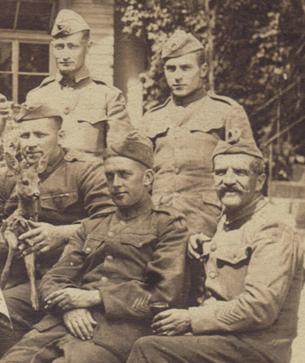 This group of five soldiers is the most interesting – mainly because one of them has chosen to pose with a small deer; perhaps the pet of the restaurant/bar where they are drinking. Both of the two soldiers seated in the front have four overseas stripes, while the one on the right must be holding the record for being the oldest soldier in the unit.