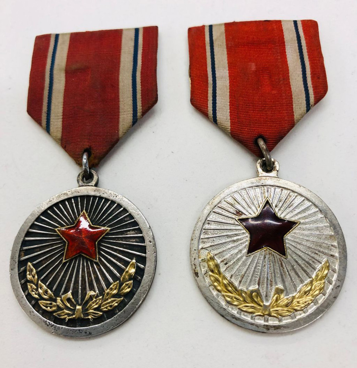 There is a distinct difference in the early issue and the later issue of the Meritorious (Labor) medal. The reverse of both have the name of the medal in Korean characters.