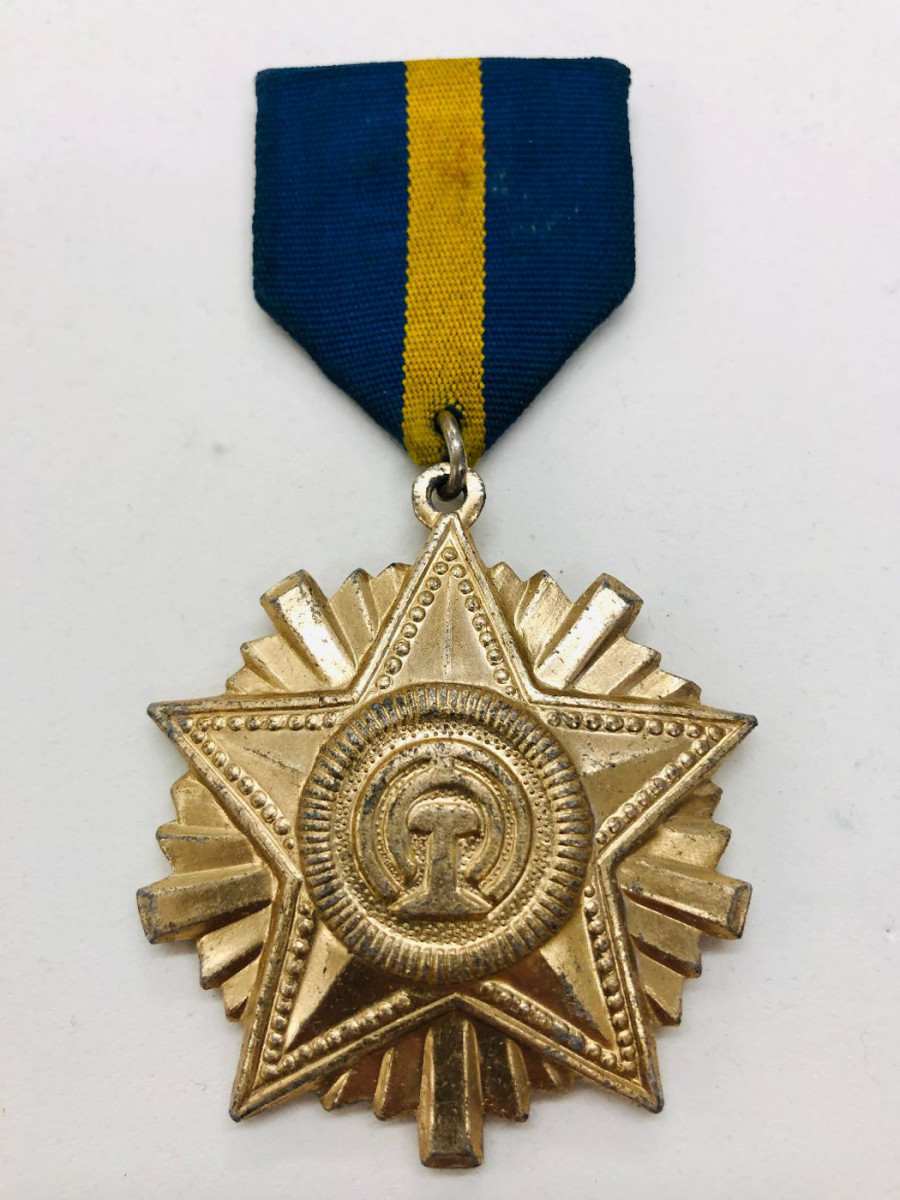 The Order of Railroad Service Honor Medal is seen in its 1st Class Version. The 2nd and 3rd class versions are easily identified by one, two, or three stripes on the respective class medals.