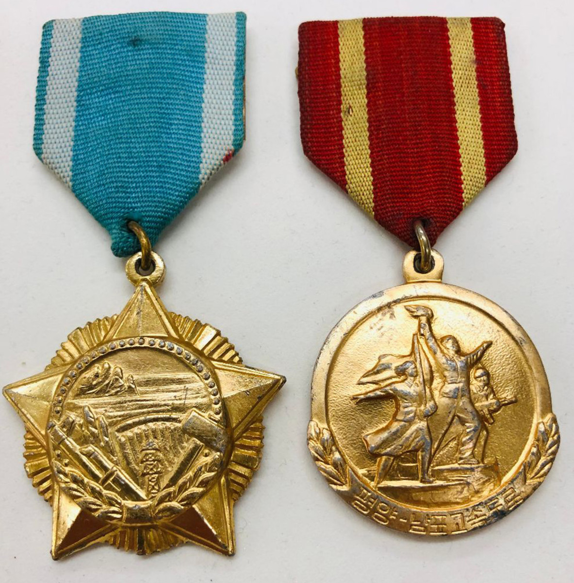 Both the Mt. Kumgang Power Plant Construction Medal and the Pyongyang-Nampo Highway Construction Medal illustrate how medals are used to reward workers in a socialist society.